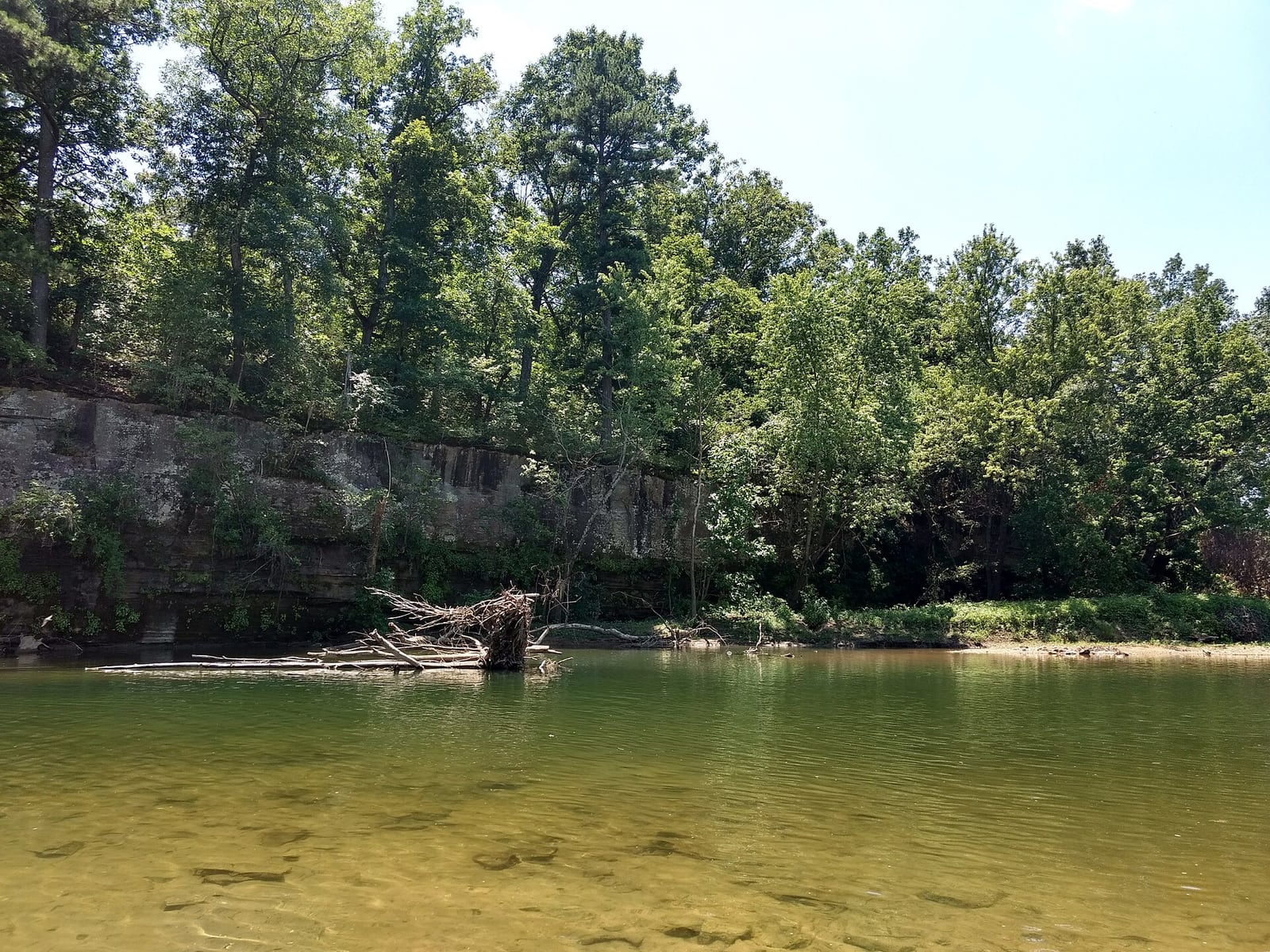 The Big Piney River bends below a wooded bluff and gravel bar near Missouri Route 17.