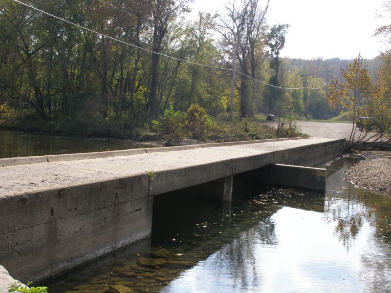 The Buffalo River passes under the Ponca low-water bridge with wooded Ozark hills above the broader upstream corridor toward Erbie.