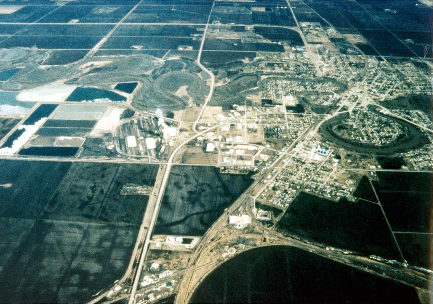 An aerial view shows the Red Lake River making several broad bends through Crookston, Minnesota.