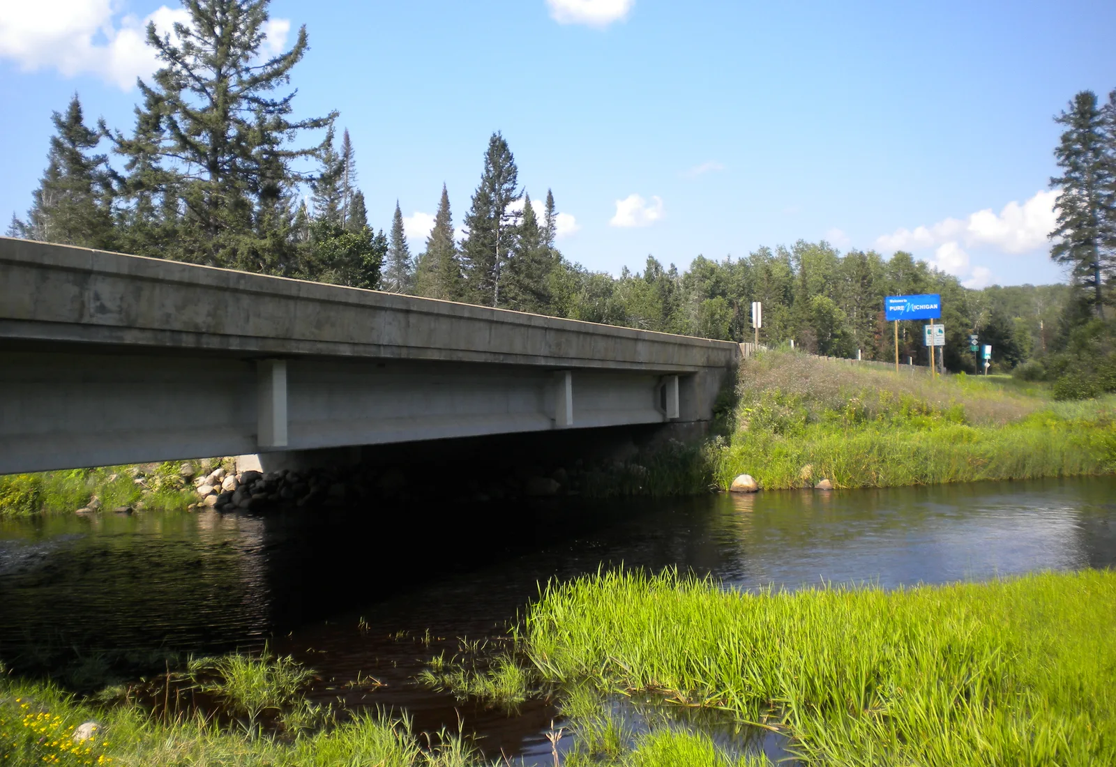 A highway bridge crosses the Brule River along the Wisconsin and Michigan border.