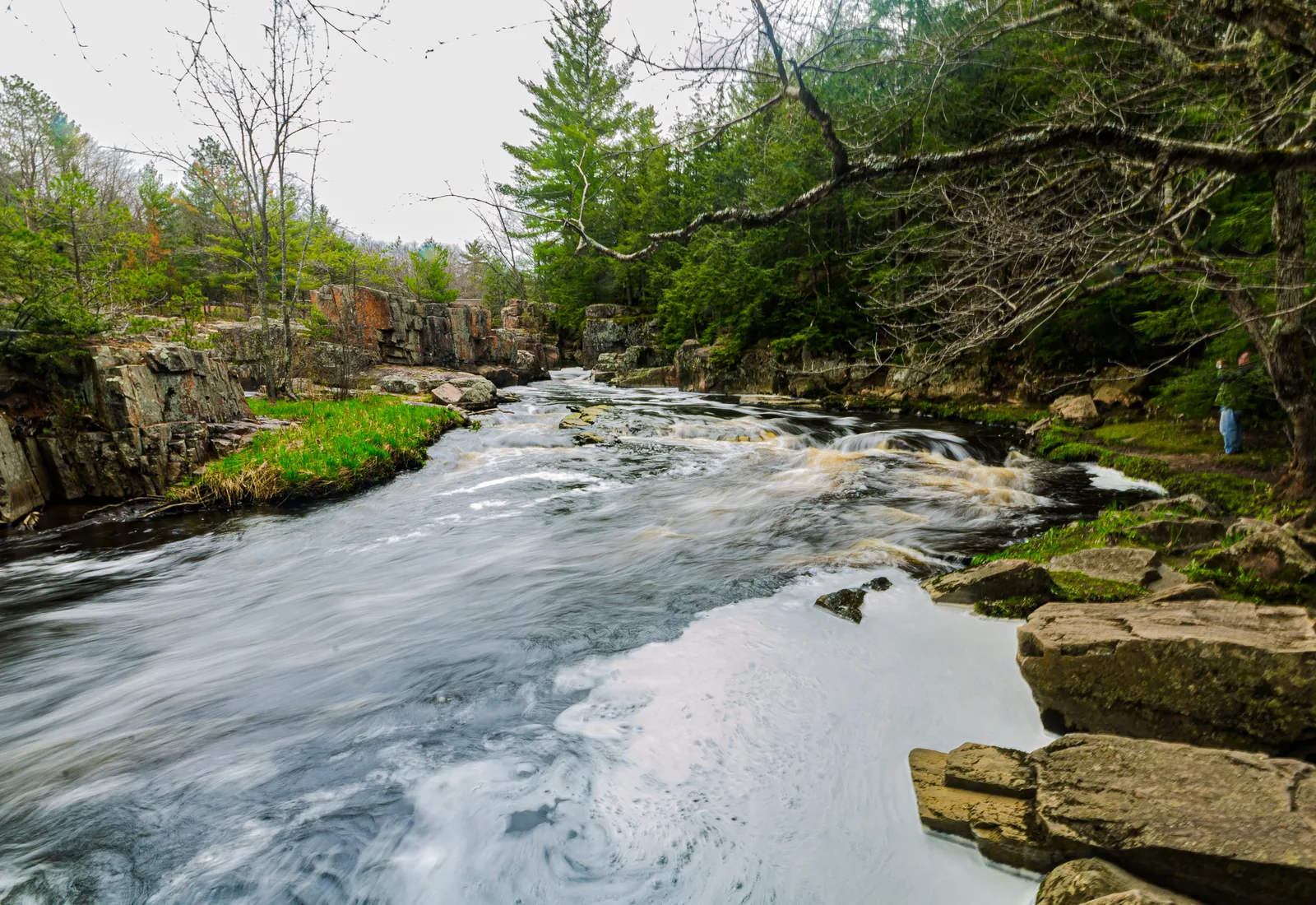 The Eau Claire River runs through rock outcrops and forest at Dells of the Eau Claire County Park.