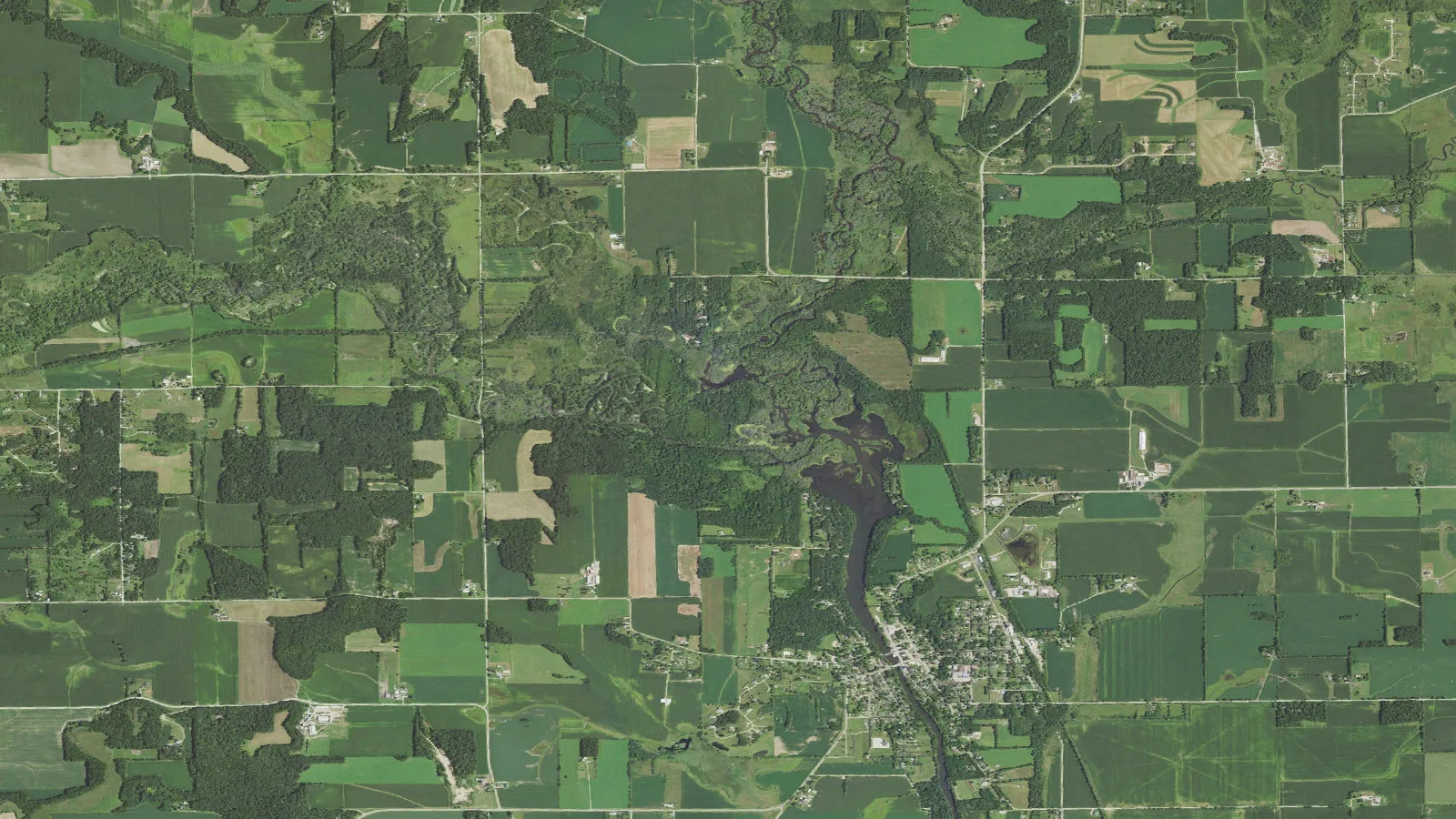 Aerial orthoimagery shows the Little Sugar River corridor from Tin Can Road toward Albany, Wisconsin.