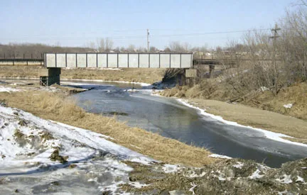 The North Fork Maquoketa River flows past wooded banks in northeast Iowa.