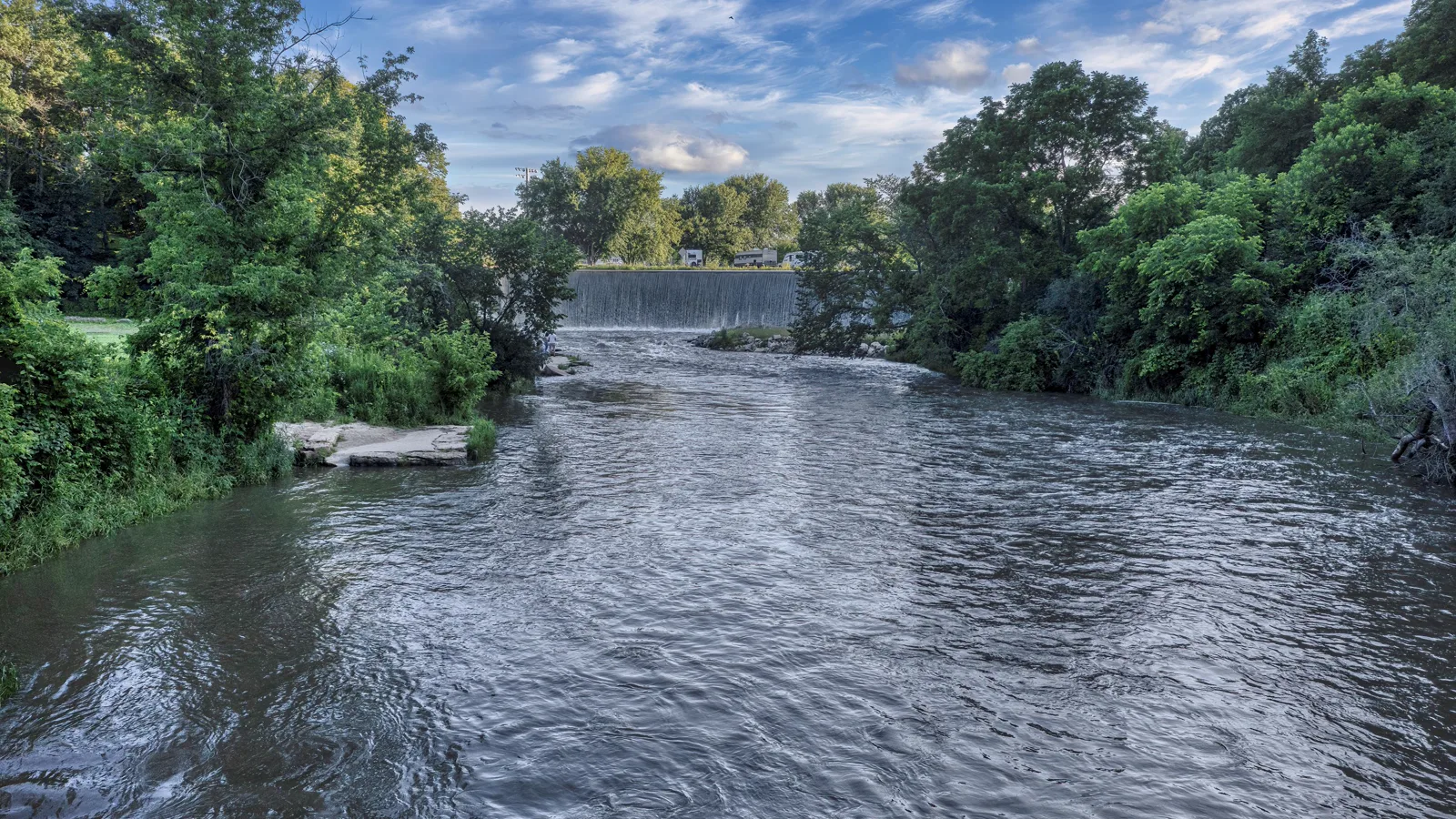 The Root River flows below the historic dam at Lanesboro, Minnesota.