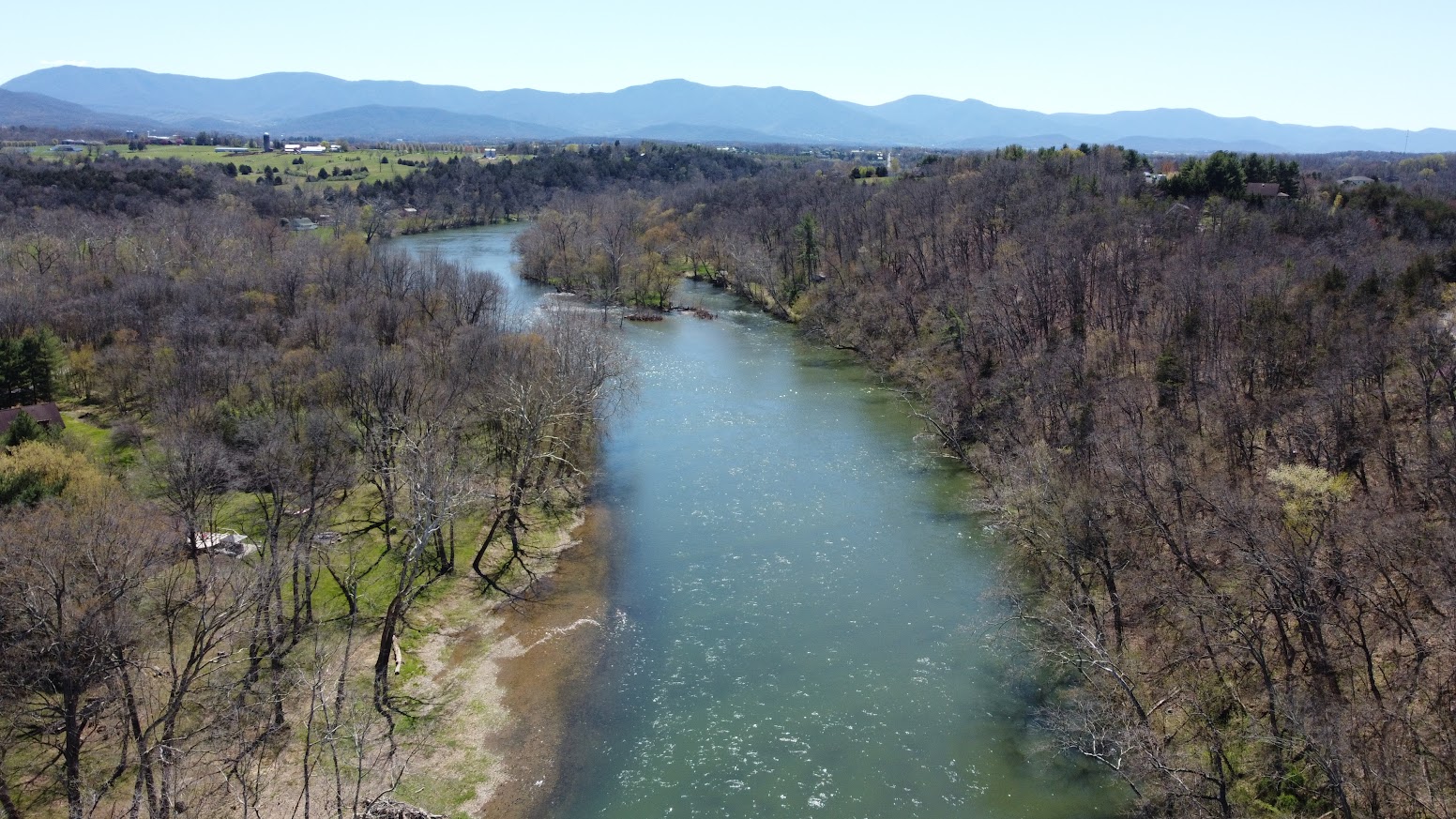 An aerial view follows the South Fork Shenandoah River near Rileyville with Blue Ridge mountains beyond.
