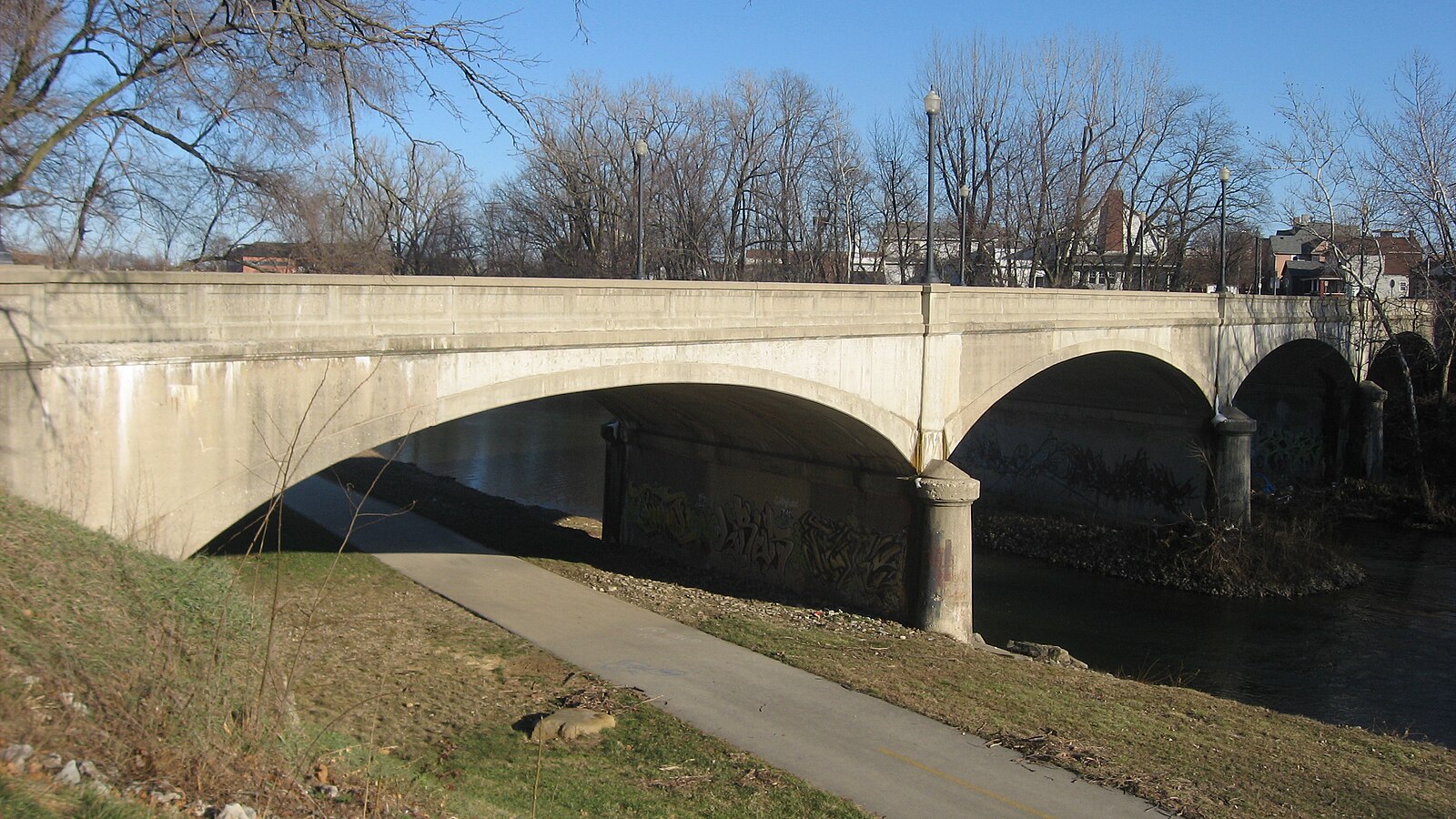The historic West Washington Street Bridge crosses the White River beside the riverfront trail in Muncie.